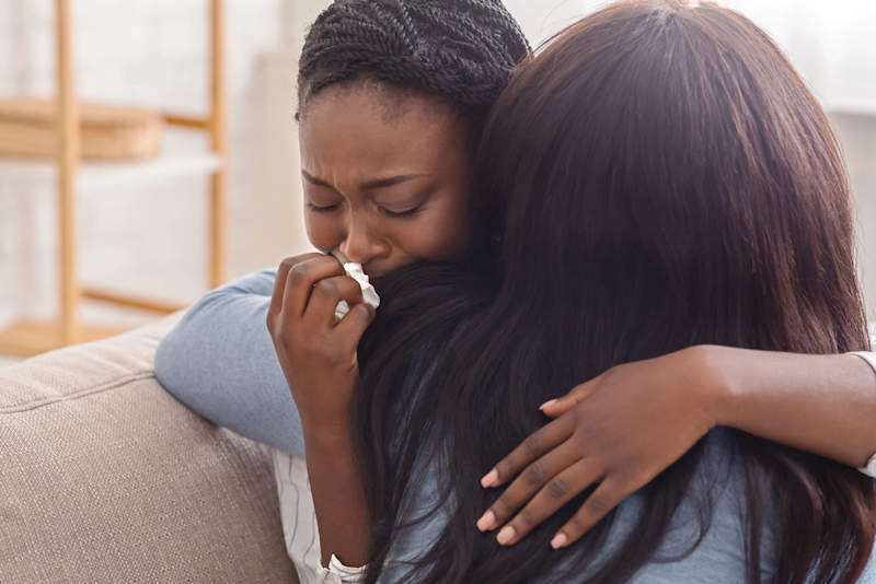 Women hugging in grief